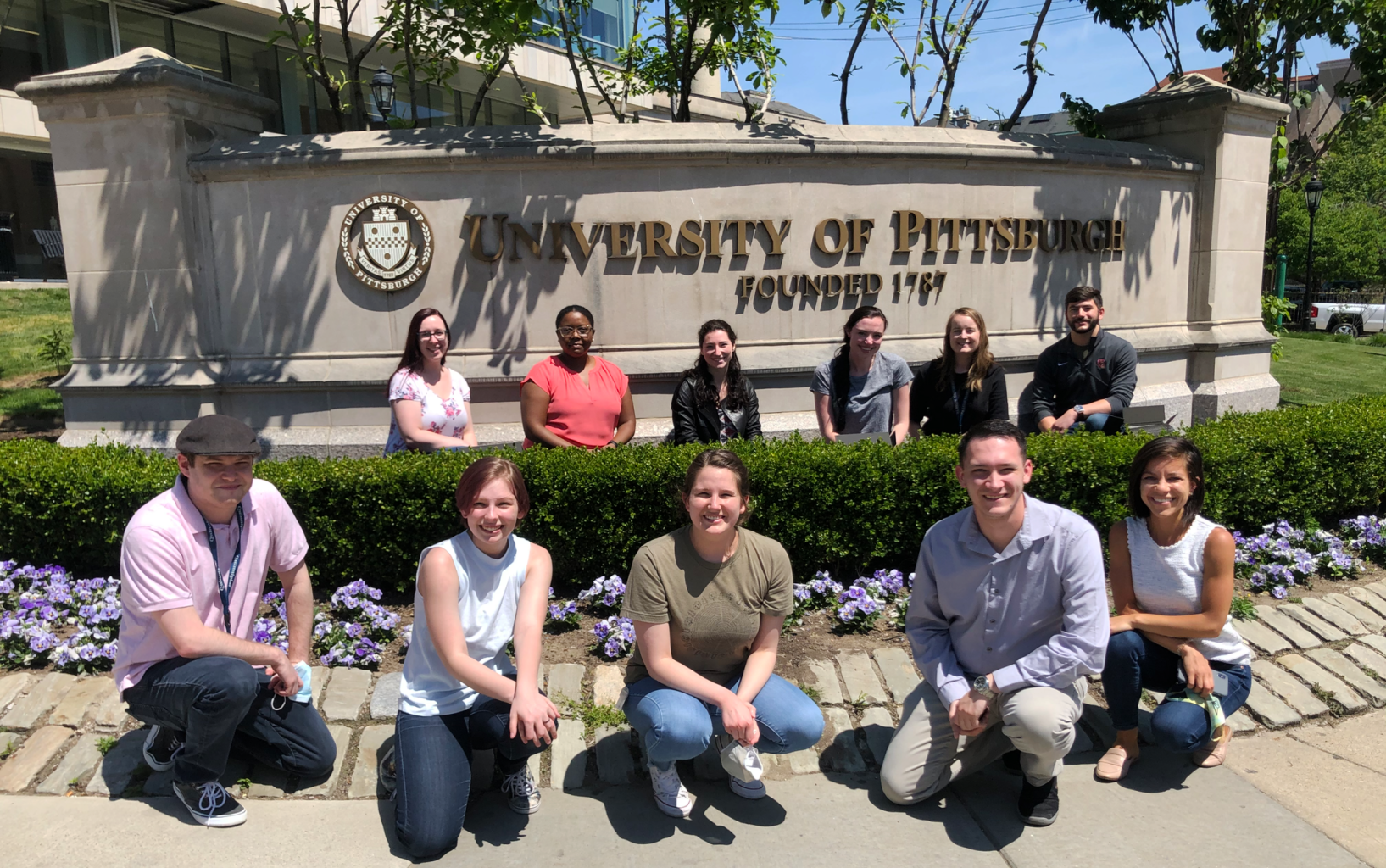Students in front of University of Pittsburgh sign