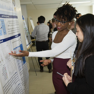 People pointing at a poster