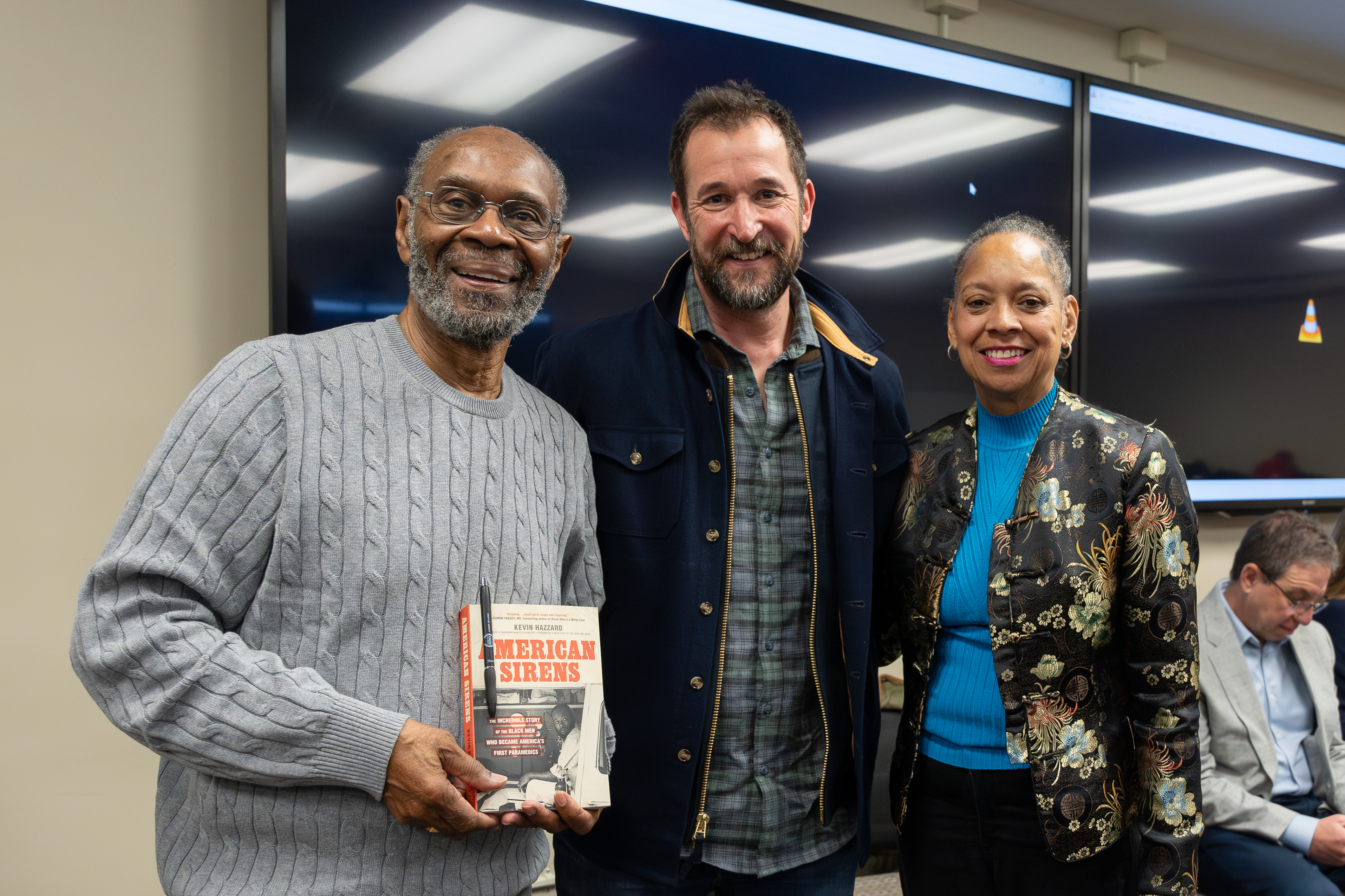 Chief John Moon, Noah Wyle and Darnella Wilson pose for a photograph