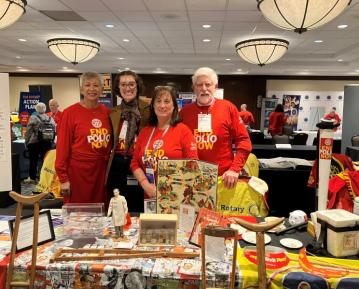 Dean Lichtveld, Emeritus Dean Burke and staff with End Polio Now t shirts and artifacts