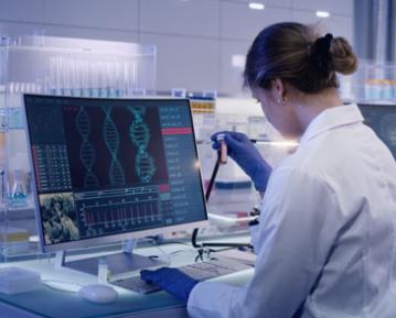 Stock lab photo of women in front of computer in lab