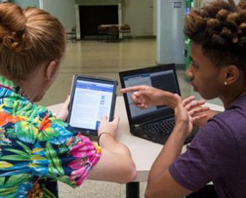 Students with iPad and laptop