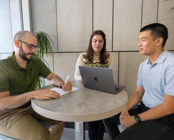 three people studying in commons