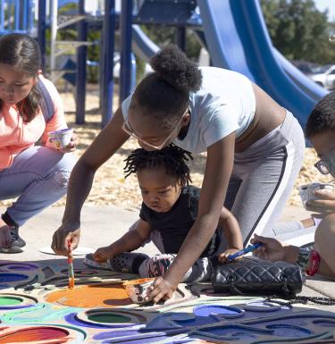 children painting at a park