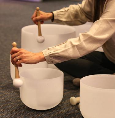 student using sound bath