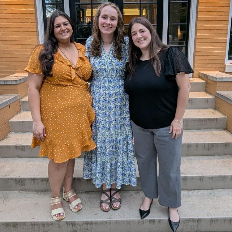 three HPM students at department celebration