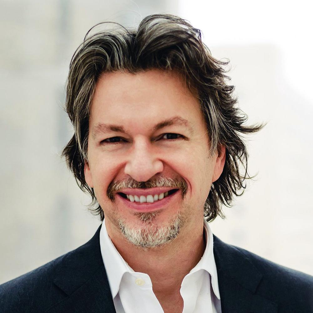 Man smiling in a white collared shirt