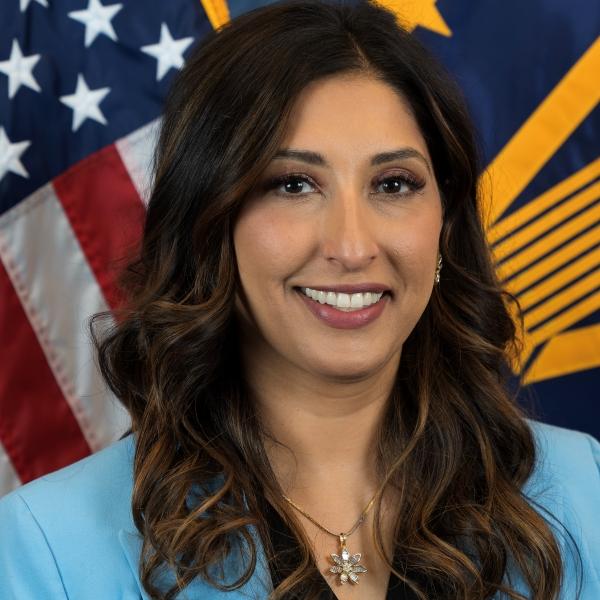 Sunaina Kumar-Giebel headsot in front of flags