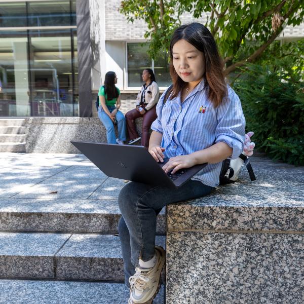 Student outside with laptop